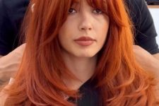 a jaw-dropping red buttefly haircut with curtain bangs and lots of volume is a fantastic idea to try