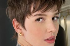a layered brunette pixie with feathered layers that provide movement and longer sides is very fresh and modern idea