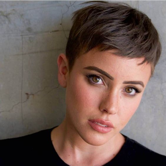 a light brunette shaggy layered pixie haircut with bangs is a stylish idea, with a soft shade and texture