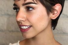 a long black pixie cut with wispy bangs and straight hair looks cool and chic, it’s a fresh and catchy idea