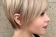 a longer pixie haircut with sleek styling and a light blondie balayage