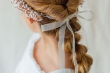 a loose and long braid, a bump on top and a beaded headband plus a bow is a cool idea for a flower girl