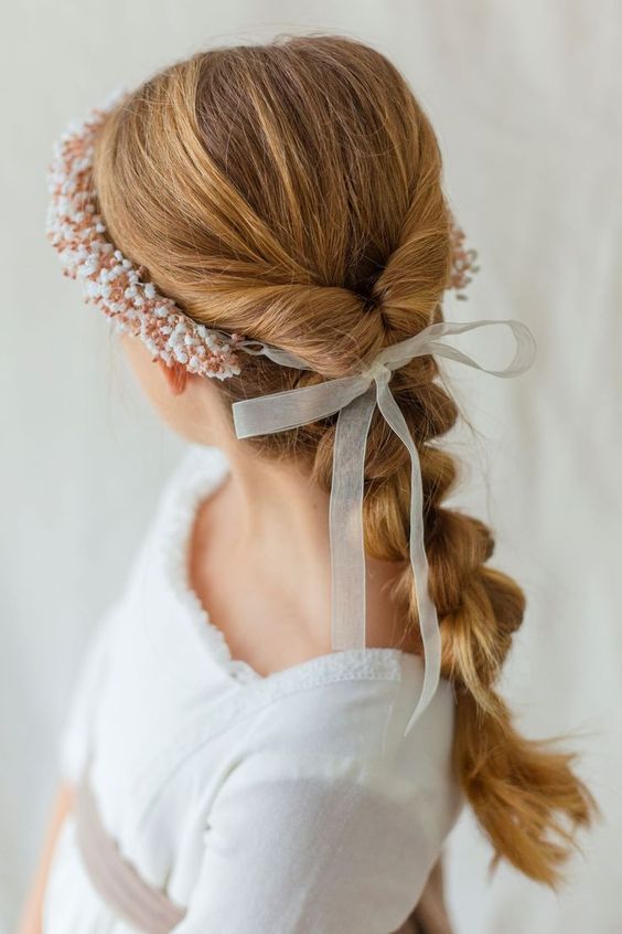 a loose and long braid, a bump on top and a beaded headband plus a bow is a cool idea for a flower girl