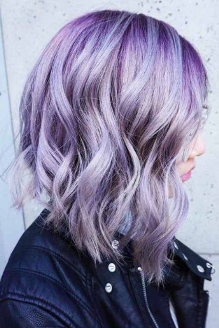 a lovely asymmetrical long wavy bob with purple and lilac hair and waves is a stylish and eye-catchy idea