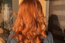 a lovely copper medium haircut with curled ends and a lot of volume looks amazing in the sun beams