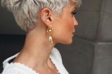 a lovely ice blonde layered pixie cut with darker root looks amazing on thick hair, for for shorter sides and back
