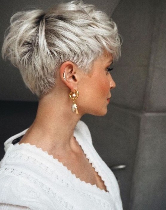 a lovely ice blonde layered pixie cut with darker root looks amazing on thick hair, for for shorter sides and back
