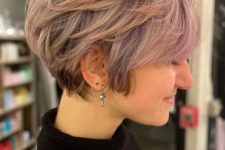 a lovely layered pink pixie bob with longer sides and side bangs is a very cool and lovely idea with a soft touch of color