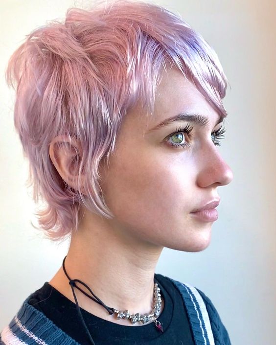 A lovely shaggy lilac to pink long layered pixie with side bangs is an eye catching idea with a bit of sot color