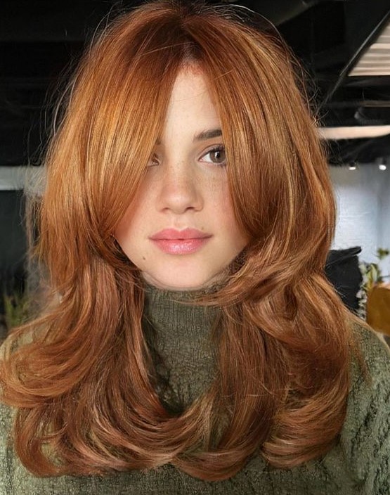 a medium ginger butterfly haircut with bottleneck bangs and curled ends is a beautiful and lovely idea