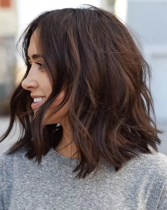 a messy and wavy layered medium-length haircut with texture and dimension is amazing to rock