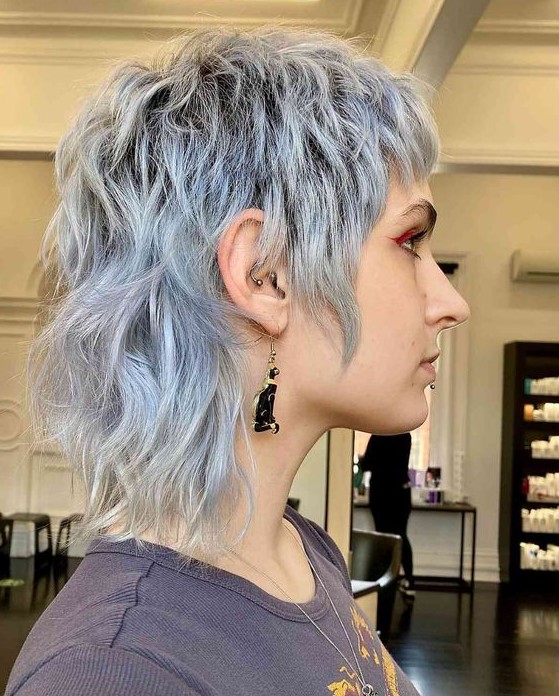 A pale blue short mullet with dimension and waves is a catchy and bold idea that looks rock style