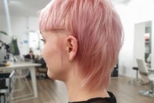 a pastel pink straight hair short mullet with sharp line bangs is a bold solution for those who are ready to make a statement