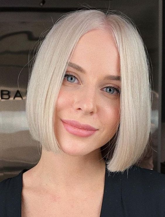 a perfect chin-length platinum blonde bob with middle part and straight hair with a bit of curled ends is a cool idea