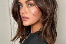 a pretty medium-length brunette hairstyle with some layers and volume is a cool idea that looks effortlessl chic