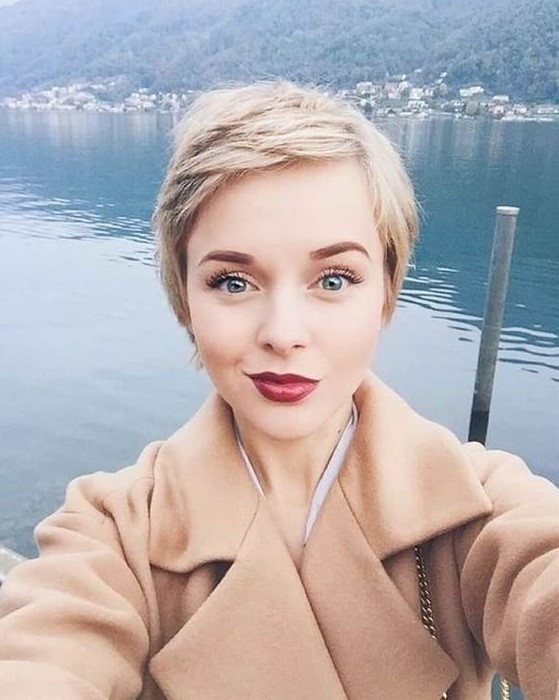 a pretty short blonde pixie with side parting and a lot of texture and volume is a cool idea that looks pretty