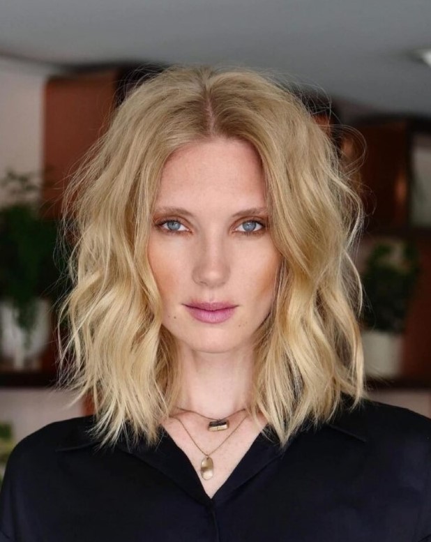 a refined blonde mid-length haircut with longer layers and waves is a lovely idea if you want something edgy
