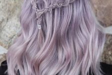 a romantic lilac half up hairstyle with a braided halo and waves is a chic boho -inspired idea