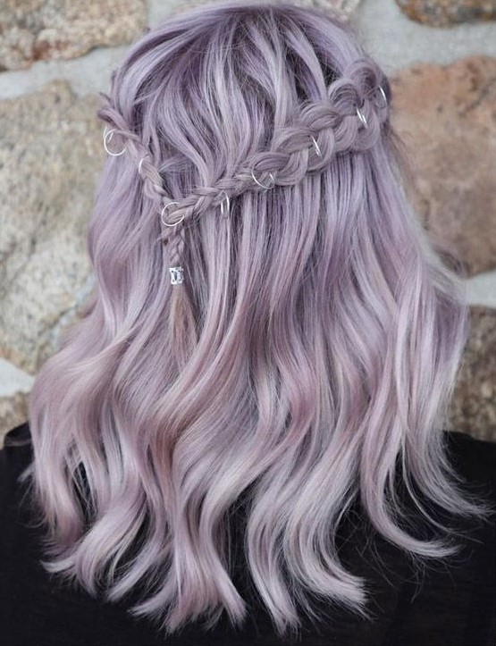 A romantic lilac half up hairstyle with a braided halo and waves is a chic boho  inspired idea