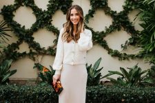 a simple and cool look with a neutral slip midi dress, a white cardigan, nude shoes and a bright bag for a winter bridal shower