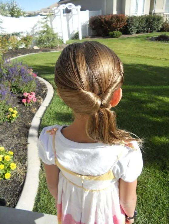 a sleek twisted low ponytail with a sleek top is a stylish idea for a modern or minimalist wedding