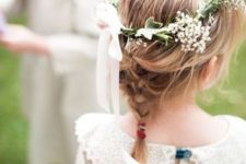 a small braid and a flower crown with a bow are a great combo for a boho flower girl look