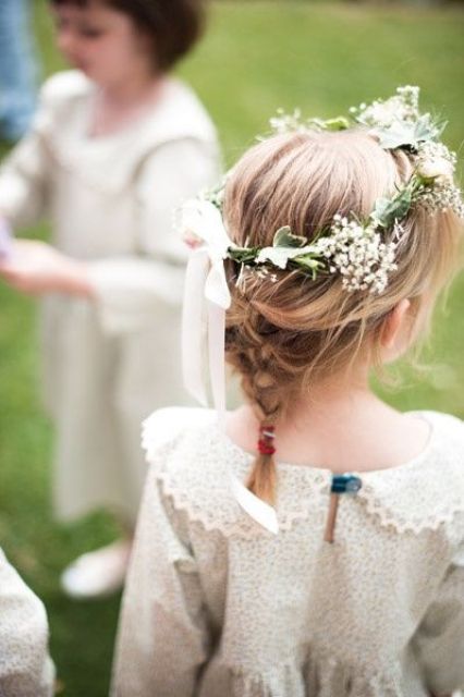 a small braid and a flower crown with a bow are a great combo for a boho flower girl look