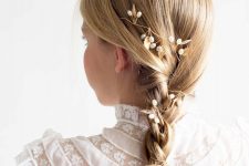 a small braid with a sleek top and some beaded hair pieces is a cool idea for a flower girl with medium length hair