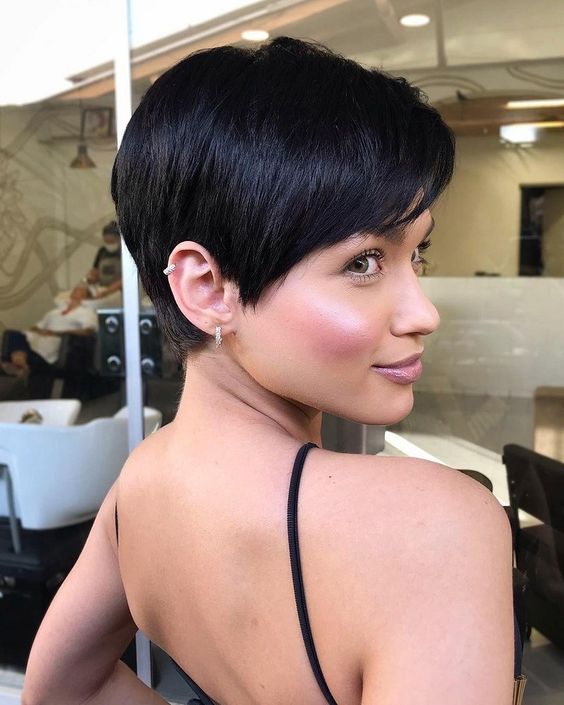 a stylish and chic long black pixie haircut with side bangs, shiny black hair and a lot of volume is amazing for anyone