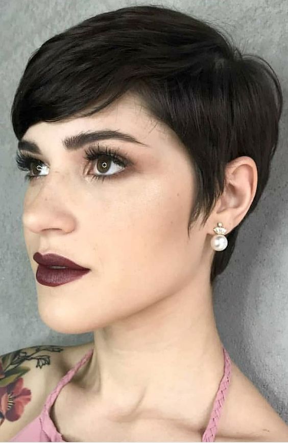 a stylish and elegant black pixie with side bangs and a bit of volume is a stylish and cool idea to rock