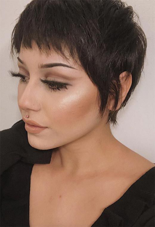 A stylish dark brunette pixie haircut with a lot of texture and some volume is an eye catchy idea to go for