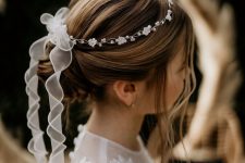 a top knot, a bump, some locks down and a flower and bead crown with a bow and long ribbon is a cool idea for a flower girl