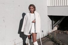 a total white look with a mini dress, a faux fur coat and tall boots is a minimal and stylish idea