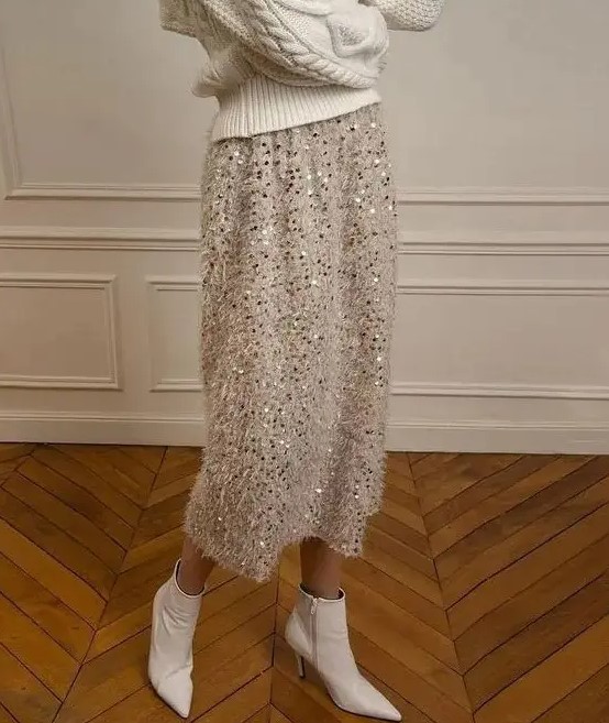 A white fluffy A line midi skirt with some sequins looks very modern, glam and girlish