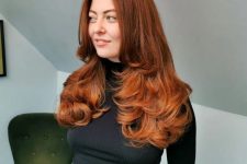 an adorable auburn to copper butterfly haircut with curled ends and a lot of volume is amazing