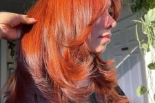 an amazingly bold and catchy red butterfly haircut on long hair, with curled ends and a lot of volume will strike everyone