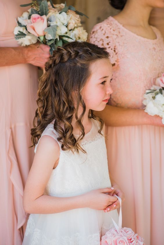 an elegant half updo with a side braid and waves down is a lovely and pretty idea for a flower girl look