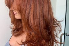 an extra long red butterfly haircut with a lot of volume, wispy bangs and curled ends is a lovely idea to look wow