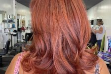 an eye-catchy red butterfly haircut with curled ends and a lot of volume is always a good idea to make your look bolder