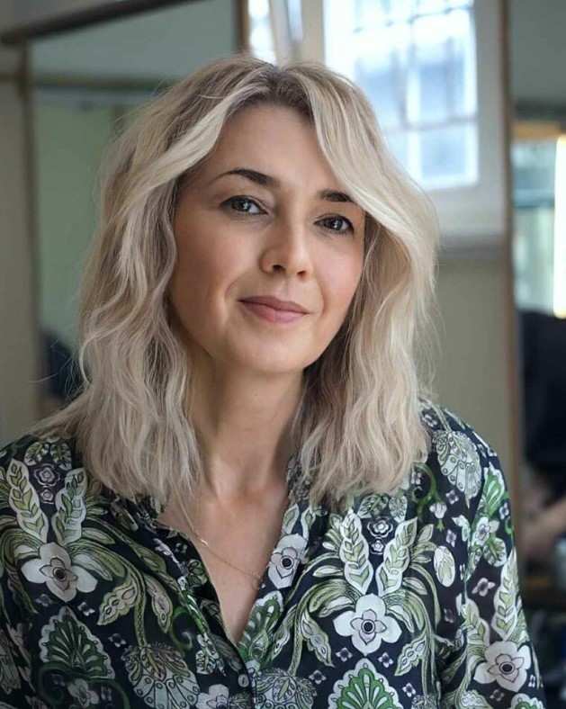 an icy blonde face-framing medium-length haircut is a lovely idea with plenty of volume and texture