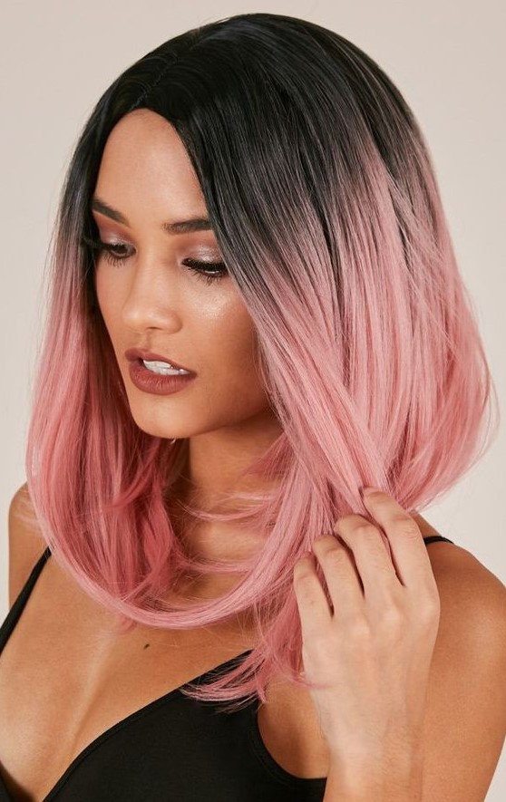 black roots with pastel pink with an ombre effect on a long bob is a very eye-catchy and bodl solution