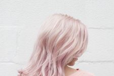 delicate medium-length pale pink hair with messy waves is a super chic and catchy solution that makes the look softer