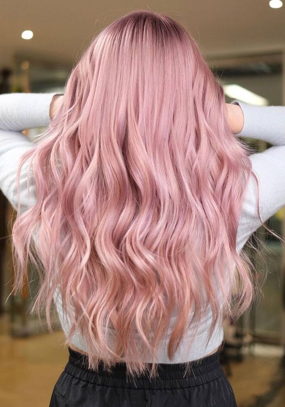 delicate pastel pink long hair with a lot of volume and waves looks very chic and very beautiful, this is a great shade to try