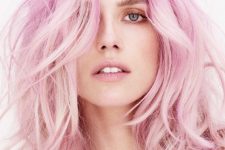 dreamy mid-length light pink messy and wavy hair with some layers is a super cool and fresh solution