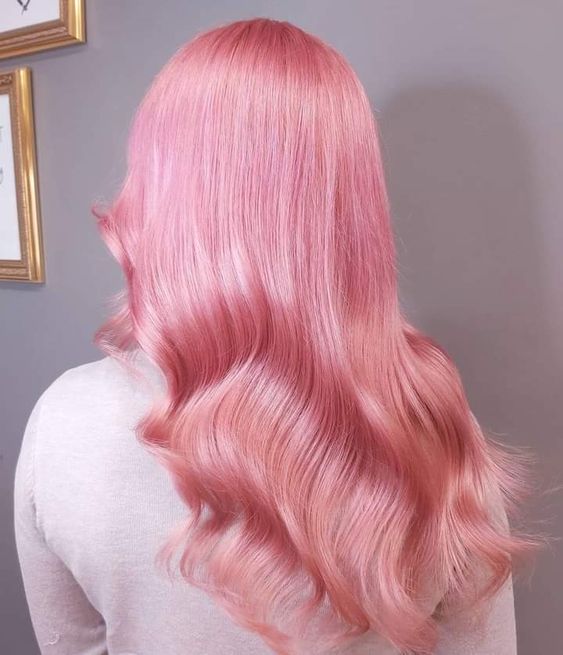 fab bubblegum pink hair with a shiny finish and some waves and volume is a beautiful and cool idea to rock