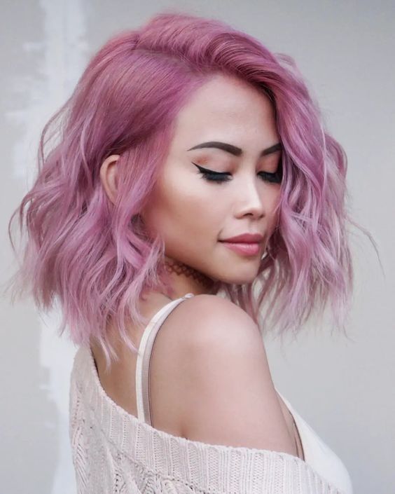 Gorgeous shoulder length pink hair with a slight ombre effect and waves is a cool solution, and much volume makes it even cooler