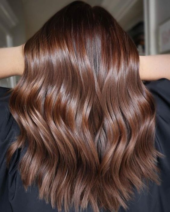 long chocolate brown hair of a lighter shade, with waves and a bit of volume is a stylish idea if you don't want to go into dark shades