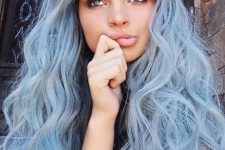 long pastel blue hair with a darker root and waves is a fantastic idea for a modern mermaid