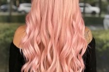long peachy pink hair with waves and volume is a stylish and chic idea for anyone who loves warm shades