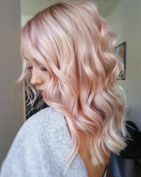 long wavy peachy rose blonde hair is a lovely solution for a spring or summer look, it will give you a soft touch